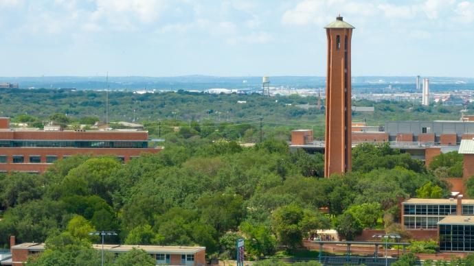 Aerial photo of campus with the tower rising above the trees